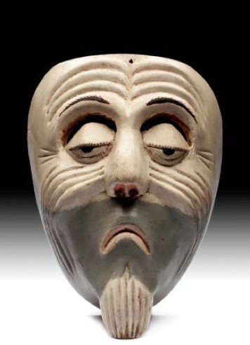 Máscara antigua que representa el rostro de un anciano. …